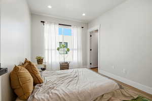Bedroom with wood finished floors and recessed lighting