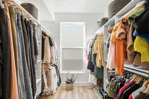 Walk in closet featuring light wood-style floors