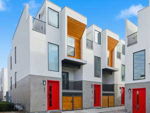 View of front of property with stucco siding and a balcony