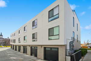 View of property with a garage and driveway