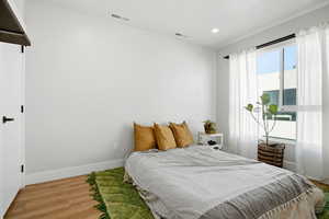 Bedroom featuring wood finished floors and recessed lighting