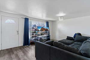 Living area with wood finished floors and baseboards