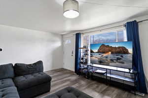 Living area with wood finished floors and baseboards