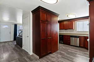 Kitchen featuring dark brown cabinets, plenty of natural light, and dark wood-style flooring