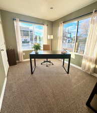 Home office with carpet and a textured ceiling