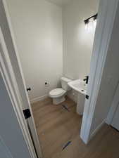 Half bathroom with light wood finished floors