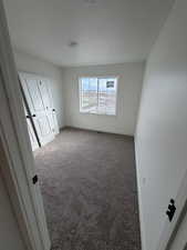 Unfurnished bedroom with carpet floors and a textured ceiling
