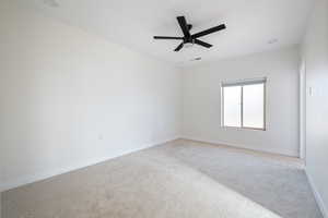 Spare room with light colored carpet and ceiling fan