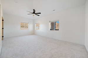 Unfurnished room featuring light carpet, a ceiling fan, and recessed lighting