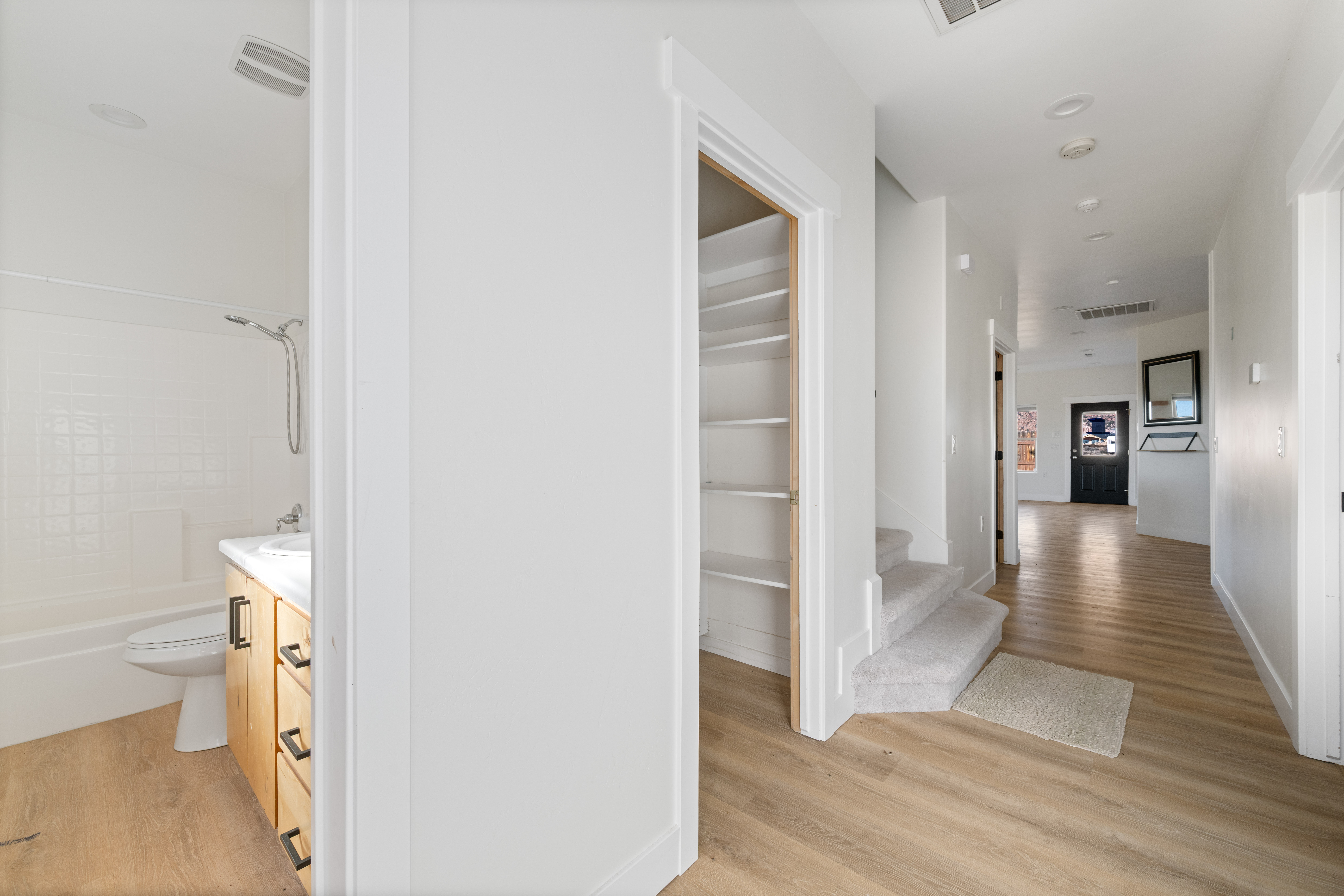 Corridor featuring light wood-type flooring and baseboards