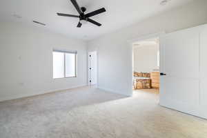 Unfurnished room with light carpet and a ceiling fan