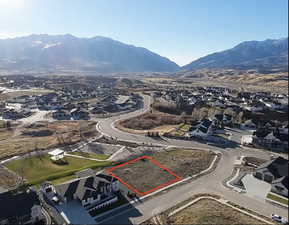 View of property location featuring property parcel outlined, nearby suburban area, and a mountainous background
