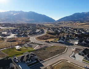 Aerial view of property's location with a mountain backdrop and nearby suburban area
