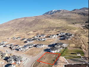 Aerial view of property's location featuring nearby suburban area, property parcel outlined, and mountains