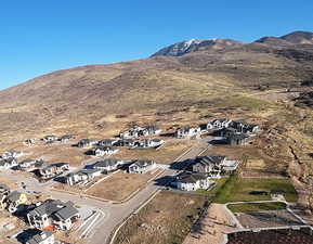 Aerial overview of property's location featuring nearby suburban area and a mountainous background