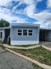 View of side of property featuring a metal roof