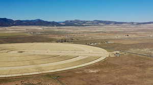 Aerial view of sparsely populated area featuring a mountainous background and a desert landscape