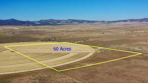 Aerial view of sparsely populated area with a mountainous background and a desert landscape