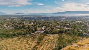 Aerial view of property and surrounding area featuring a mountainous background