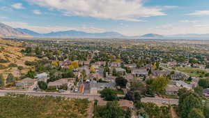 Aerial view of residential area featuring a mountainous background