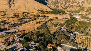 Aerial view of property and surrounding area featuring rows of crops and rural landscape
