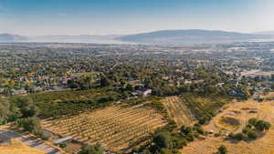 Aerial overview of property's location featuring a mountain backdrop, extensive farmland, and rural landscape