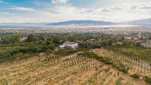 Aerial view of sparsely populated area featuring a mountainous background and extensive farmland