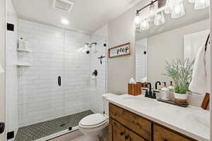 Full bath with vanity, a stall shower, and recessed lighting