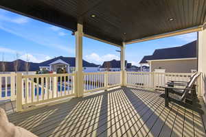 Wooden terrace featuring a residential view