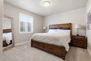 Bedroom with light colored carpet