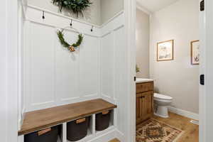 Mudroom featuring light wood-type flooring and baseboards