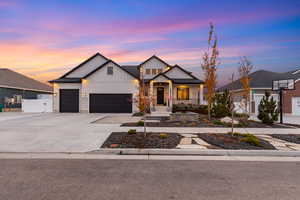 Modern inspired farmhouse with board and batten siding, driveway, a porch, and a garage