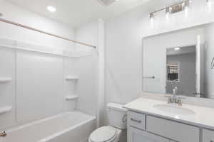 Full bath with vanity, washtub / shower combination, and recessed lighting