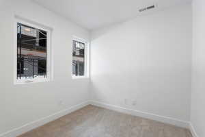 Carpeted empty room with baseboards