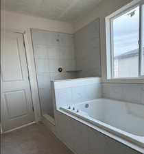 Master Bath with extra deep garden tub, separate shower with stunning tile-lots of natural light