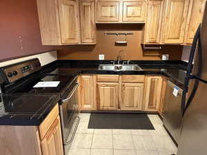Kitchen featuring appliances with stainless steel finishes and light tile patterned flooring