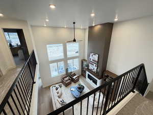 Stairs featuring a high ceiling, recessed lighting, wood finished floors, and ceiling fan