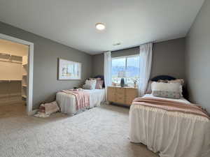 Bedroom featuring a spacious closet and carpet floors