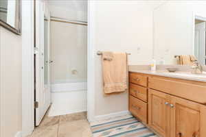 Full bathroom featuring vanity and light tile patterned flooring