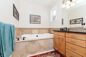 Bathroom with vanity and a garden tub