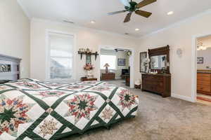 Bedroom featuring ornamental molding, a ceiling fan, light carpet, and recessed lighting