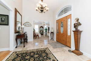 Foyer with a chandelier and a high ceiling