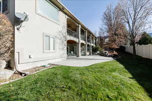 Rear view of property with a patio, stucco siding, a fenced backyard, ceiling fan, and a balcony