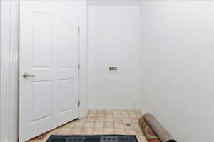 Laundry area with hookup for a washing machine and baseboards