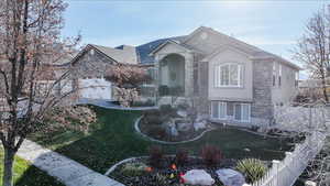 View of front of home with stucco siding and stone siding