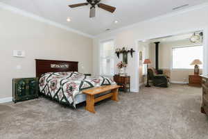 Bedroom featuring light carpet, crown molding, multiple windows, ceiling fan, and recessed lighting