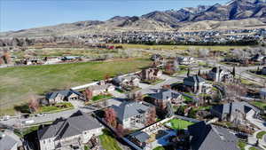Aerial overview of property's location featuring a mountain backdrop and nearby suburban area