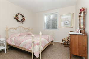 Bedroom featuring carpet flooring and baseboards