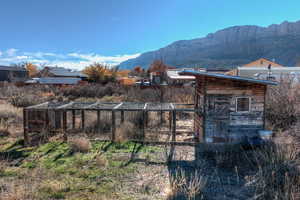 View of yard with an outdoor structure and a mountain view