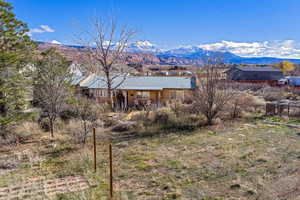 Rear view of house featuring a mountain view and stucco siding